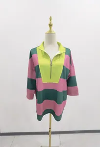 Close-up of oversized color-block striped sweatshirt with half-zip V-neck detail