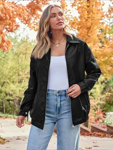 Detailed view of a woman wearing an oversized black motorcycle leather jacket in autumn