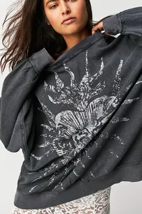 Close-up of vintage washed gray sweatshirt with graphic print detail.