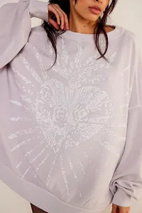 Close-up of distressed heart graphic on lavender oversized vintage sweatshirt