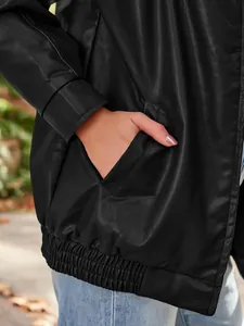 Detailed view of the side pocket on a black oversized faux leather biker jacket