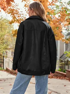 Detailed back view of a women's oversized black faux leather motorcycle jacket in autumn.