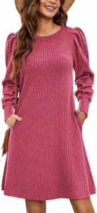 Detailed macro view of a pink knit dress featuring elegant puff sleeves and ribbing