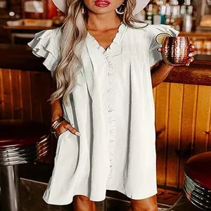 Close-up of a white V-neck dress featuring ruffled sleeves and a loose, comfortable fit.
