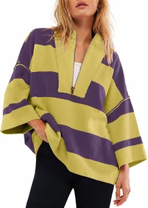 Close-up of an oversized striped half-zip sweatshirt with purple and yellow color blocking.