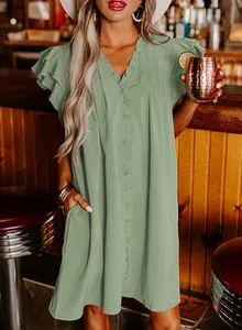 Detail view of a loose-fitting sage green summer dress with V-neck and ruffled sleeves