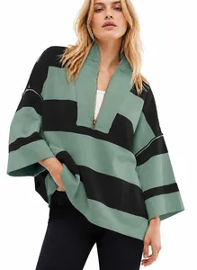 Close-up detail of oversized green and black striped half-zip sweatshirt for women
