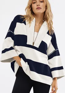 Close-up of oversized navy and cream striped half-zip sweatshirt on model