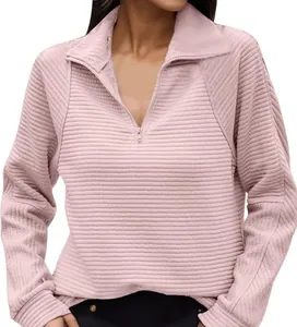 Close-up of pink textured half-zip sweatshirt with a stylish ribbed snake bone pattern