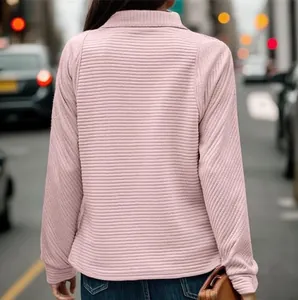 Back view of a pink snakeskin textured sweatshirt for women in a street style setting