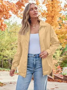 Model wearing an oversized light yellow biker leather jacket against an autumn backdrop