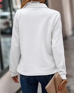 Detailed back view of white ribbed sweatshirt with stand-up collar and texture