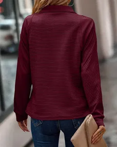 Back view of women's burgundy ribbed sweatshirt showing textured snake bone pattern details.