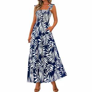 Full view of blue palm leaf print summer dress with smocked bodice and tie straps
