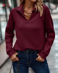 Detailed view of a maroon snake bone textured quarter-zip sweatshirt for women's fall fashion