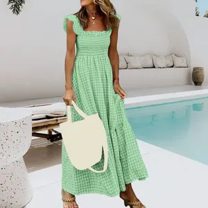 Green gingham smocked maxi dress with ruffled sleeves and a tiered skirt for summer.