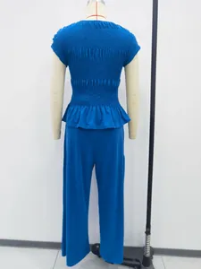 Back view detail of elegant blue smocked ruffled top and wide-leg casual pants set