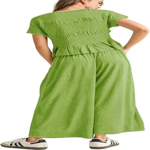 Back view of a lime green smocked top and wide-leg cotton trousers two-piece set