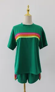 Front view of green women loungewear set with vibrant rainbow stripes on mannequin