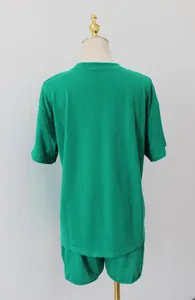 Detailed back view of a minimalist green two-piece loungewear set on a dress form