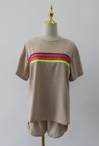 Detailed view of women's beige lounge set with vibrant neon chest stripes