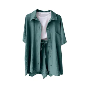 Close-up detail of women's casual cotton linen shirt and shorts two-piece set in teal green.