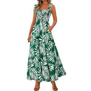 Elegant green and white floral smocked maxi dress with tie straps and tropical leaf print