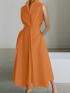 Detailed view of an elegant orange V-neck sleeveless midi dress with button accent