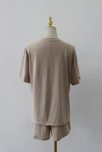 Back view of a minimalist beige two-piece loungewear set including t-shirt and shorts