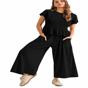 Detail of black two-piece set with ruffled top and wide leg trousers for women