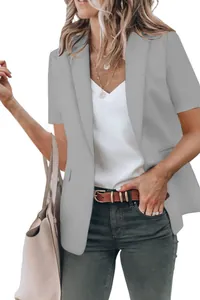 Detail shot of a stylish grey women's short-sleeved blazer over a white v-neck top