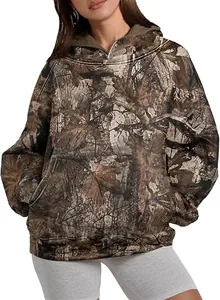 Detail view of women's oversized hoodie with a realistic forest leaf camo print