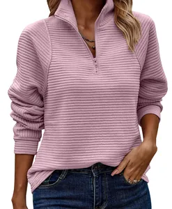 Macro detail of pink snake-bone textured long sleeve quarter-zip sweatshirt for women