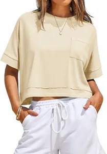 Macro view of women's cream oversized crop top t-shirt featuring a front pocket
