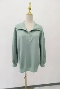 Oversized sage green Henley sweatshirt with button-down collar on mannequin