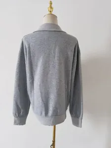 Back view of a minimalist gray long sleeve sweatshirt for women on a mannequin display