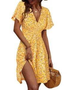Detailed view of yellow floral V-neck midi dress with flutter sleeves and side slit
