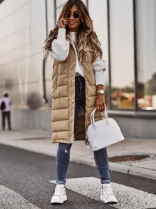 A stylish long khaki quilted puffer vest featuring a hood and snap button closure