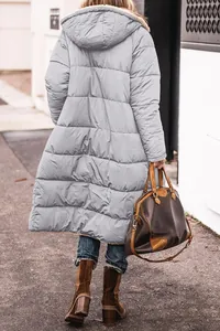 Back view of a long light grey hooded puffer coat featuring a warm quilted design for women