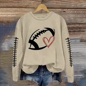 Detailed view of women's khaki sweatshirt with football and heart graphic print