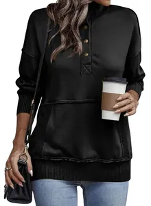 Close-up of black street style sweatshirt with button collar and front pocket.