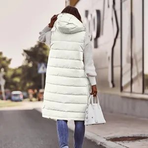 Back view of a long white hooded quilted vest styled with a white sweater and jeans