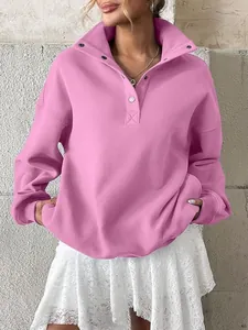 Detailed view of women's pink oversized fleece sweatshirt with Henley collar and buttons