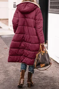 Back view detail showing the quilted texture of a long maroon hooded puffer coat for winter
