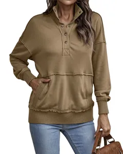 Detail view of khaki long sleeve sweatshirt featuring button collar and front pocket