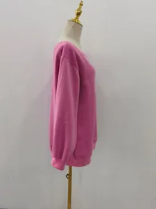 Detailed side view of a solid pink long-sleeved sweatshirt displayed on a white mannequin