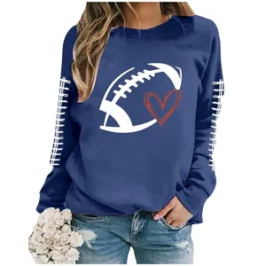 Detail of women's blue sweatshirt featuring a white rugby ball and red heart graphic print