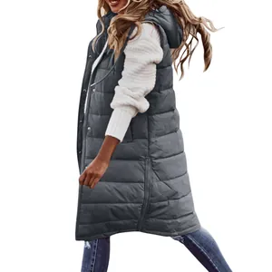 Detailed side view of a long dark gray hooded puffer vest worn over a white sweater.
