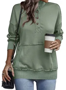 Close-up detail of sage green long sleeve button sweatshirt with kangaroo pocket