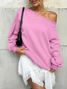 Detail of pink off-the-shoulder sweatshirt with ribbed cuffs and a loose comfortable fit